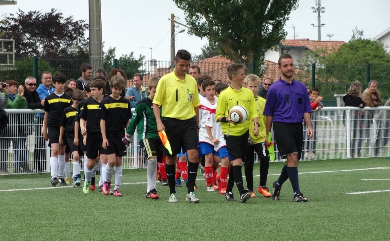 Quentin au centre assisté de son frère Bastien (en jaune) et Manu Duarte (en violet) lors de la dernière finale U11 du lissardy 2015